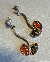 Full view of both silver amber earrings