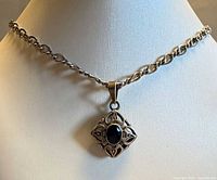 Full view of necklace on bust showing chain style and pendant