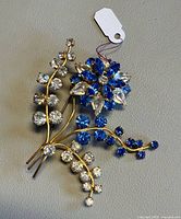 Front view showing blue and clear crystals and gold-tone stems