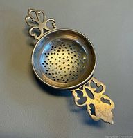 Top view showing perforated bowl and one handle