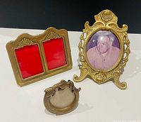 Front view of three brass frames