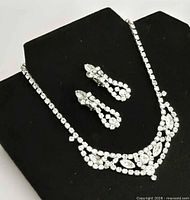 Necklace with earrings on display bust