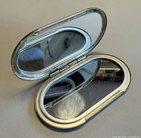 Compact mirror open showing both glass sides