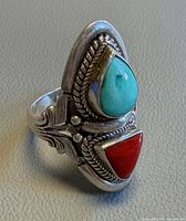 Front view of ring showing turquoise and coral stones and silver detailing