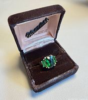 Ring in open brown velvet presentation box