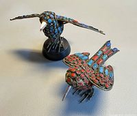 Both brass bird figurines side by side showing inlay