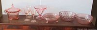 Group shot of all seven pink Depression glass pieces