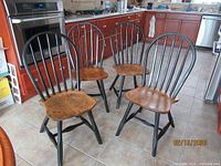 Three of the four Windsor chairs angled in kitchen setting