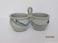 Front view of conjoined bowls showing glaze and handle