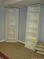 Both bookcases in corner of room showing relative sizes and styles