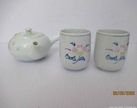 Teapot and two cups front view showing overall style and matching pattern