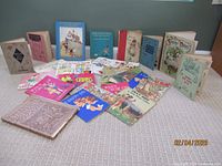 Group shot of all twenty children’s books arranged on carpet