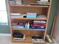 Full bookshelf view showing majority of stationery items