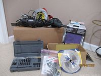 Box with Makita grinder, Makita saw, B&D drill, Dremel MM20, Ryobi bit set, saw blade, sanding sheets