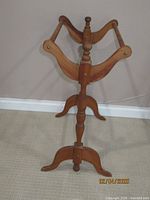 wooden stand with three curved arms and turned center column