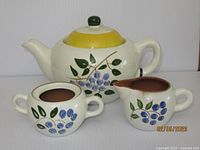 Pitcher with lid, creamer, sugar bowl front view