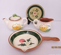 Group view of all four Stangl pottery pieces showing patterns and sizes