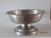 Side view of footed pewter bowl