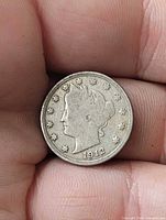 Obverse of 1912 Liberty Head V Nickel held between fingers