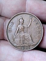 Reverse of 1945 UK one penny coin showing seated Britannia, denomination and date