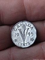 Reverse of 1945 Canadian Victory nickel showing V torch design