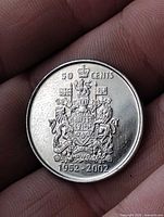 Reverse side showing 50 CENTS inscription, Canadian Coat of Arms, dates 1952-2002