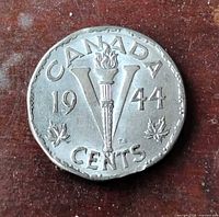 Reverse showing 1944 date, V torch design, leaf sprigs, 12-sided shape