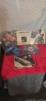 All six Johnny Cash LPs displayed on red cloth, showing front cover artwork