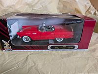 Boxed 1:18 red 1957 Ford Thunderbird model car front view