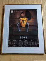 Full view of framed 2008 Crosby Tim Hortons calendar behind glass