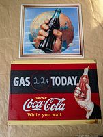 Front view showing graphics of both metal Coke signs