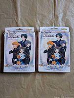 Front view of two Fruits Basket Friends of the Zodiac card game boxes
