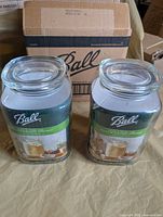 Pair of packaged Ball Stack & Store glass jars in front of original shipping box