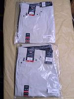 Two packaged pairs of Chaps stone jeans showing front tags