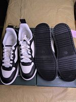 Top view of both pairs on box showing uppers and laces