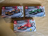 All three sealed Lego Speed Champions F1 sets displayed face up