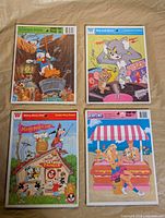 All four puzzles laid out: Donald Duck, Tom and Jerry, Mickey Mouse Club, Barbie