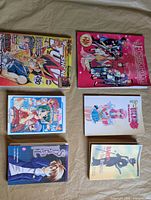 All six manga/anime books laid out front covers visible