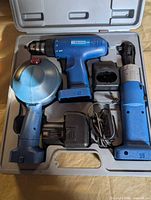 Entire set in molded case showing drill, lights, charger, battery and adapter