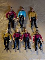 All seven loose Star Trek action figures laid out on surface