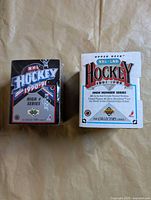 Front view of both sealed card set boxes