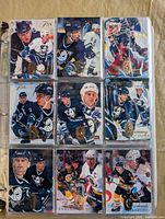 Binder page showing nine premium Fleer Flair hockey cards with metallic foil logo