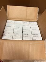Open shipping carton showing 12 inner boxes of tape