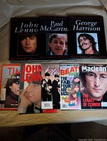 Three Illustrated Beatles hardcover books and five magazines laid out