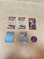 All items in lot: three packs, two cards, one coin