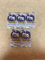 Front view of all five sealed hockey card packs