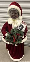 Front view of Mrs. Santa Claus figure with wreath and tag