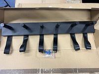 Rack in box showing six pegs, six leather loops and hardware