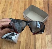 Unboxed Delta Plus Avion safety glasses held in hand with box in background