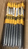 Box containing multiple packaged DEWALT rotary hammer drill bits; lot represents one unit